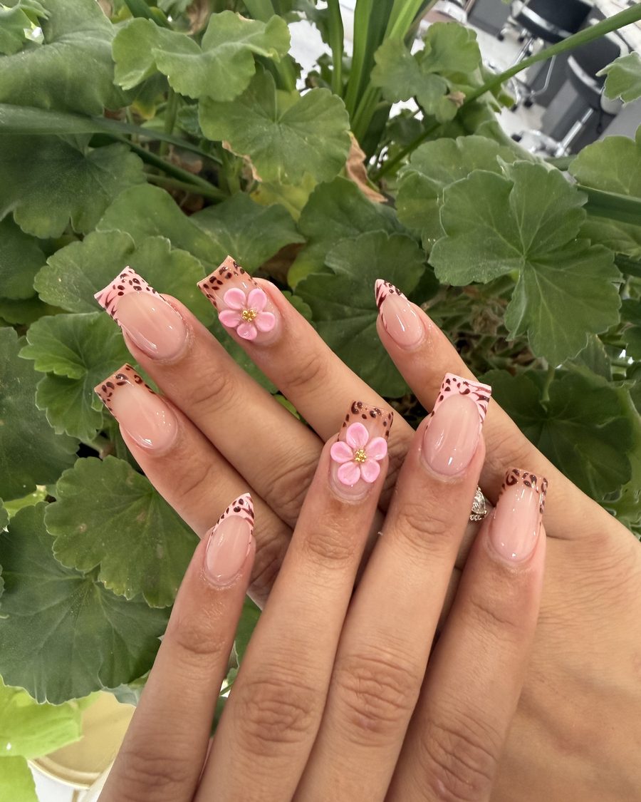 Coffin-shaped nails with leopard-print French tips and hand-sculpted 3D pink flowers